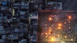 A mass cremation of COVID-19 victims is seen at a crematorium parking lot in New Delhi, on April 22, 2021.