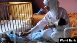 A healthcare worker tends to orphans in Marrakech, Morocco. The country is making substantial progress in improving childhood and maternal health, a UN Millennium Development Goal. (World Bank)