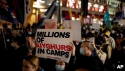 FILE - Demonstrators supporting Tibetans, Uyghurs and Hong Kongers take part in a protest against the Chinese Communist Party, as they march along Regent Street toward the Chinese Embassy, in London, Oct. 1, 2021. 