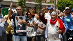 Supporters of Egypt's ousted President Mohammed Morsi chant slogans at a sit-in in Nasser City, suburb of Cairo, July 7, 2013.