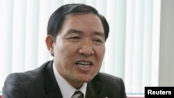 File - Duong Chi Dung, a former executive of a Vietnamese state-owned shipping firm who made a confession as a witness at his younger brother's trial this week, at his former office, Hanoi, 2007.