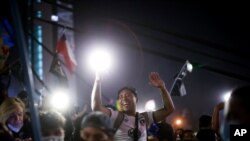 People gather at Plaza Italia on the day Chileans voted in a referendum to decide whether the country should replace its 40-year-old constitution, written during the dictatorship of Gen. Augusto Pinochet, in Santiago, Oct. 25, 2020.