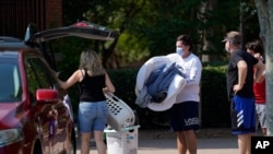 Students and parents begin to move student's belongings out of Bragaw Hall at N.C. State University in Raleigh, N.C., Aug. 27, 2020.