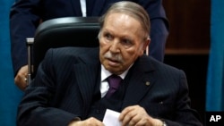 FILE - Algerian President Abdelaziz Bouteflika prepares to vote in Algiers, May 4, 2017.