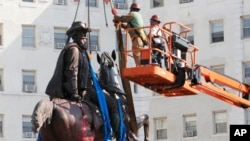 Crews remove a statue of Confederate General J.E.B. Stuart on Monument Avenue July 7, 2020, in Richmond, Va.