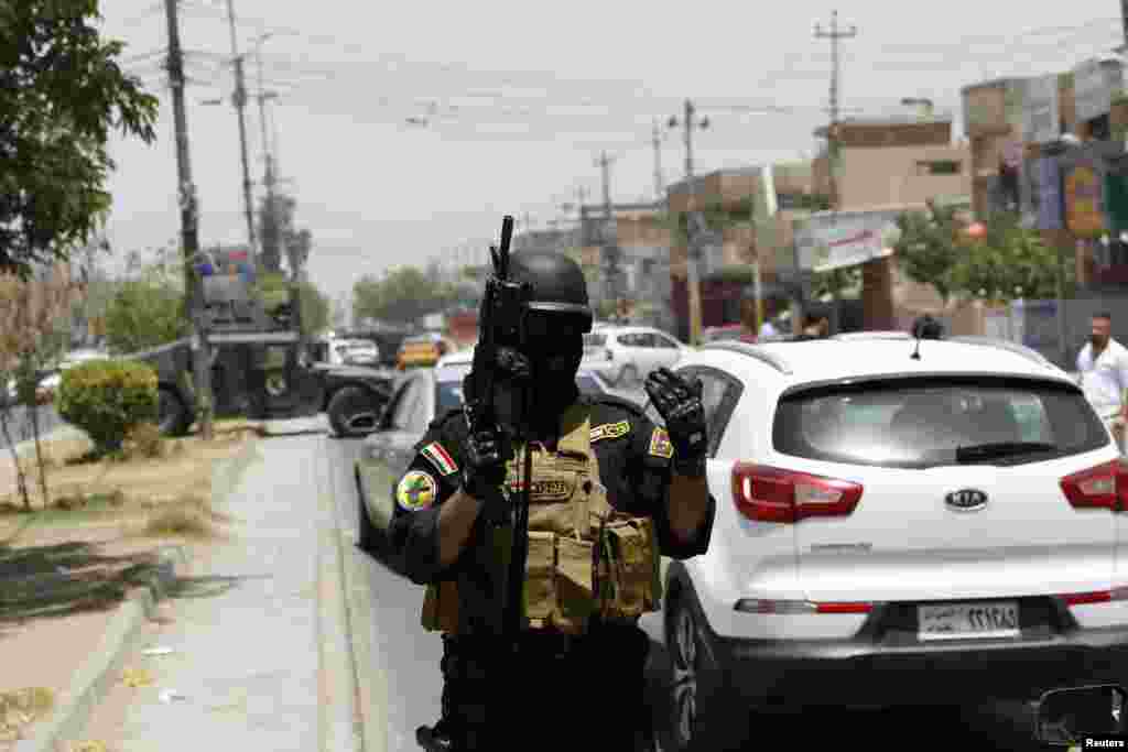 A member of the Iraqi Special Operations Forces stands guard during an intensive security deployment in Baghdad's Amiriya district, June 18, 2014.