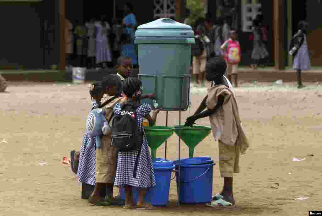 Students wash their hands as a preventive measure against Ebola at Anono school in Abidjan, Ivory Coast, Sept. 25, 2014.