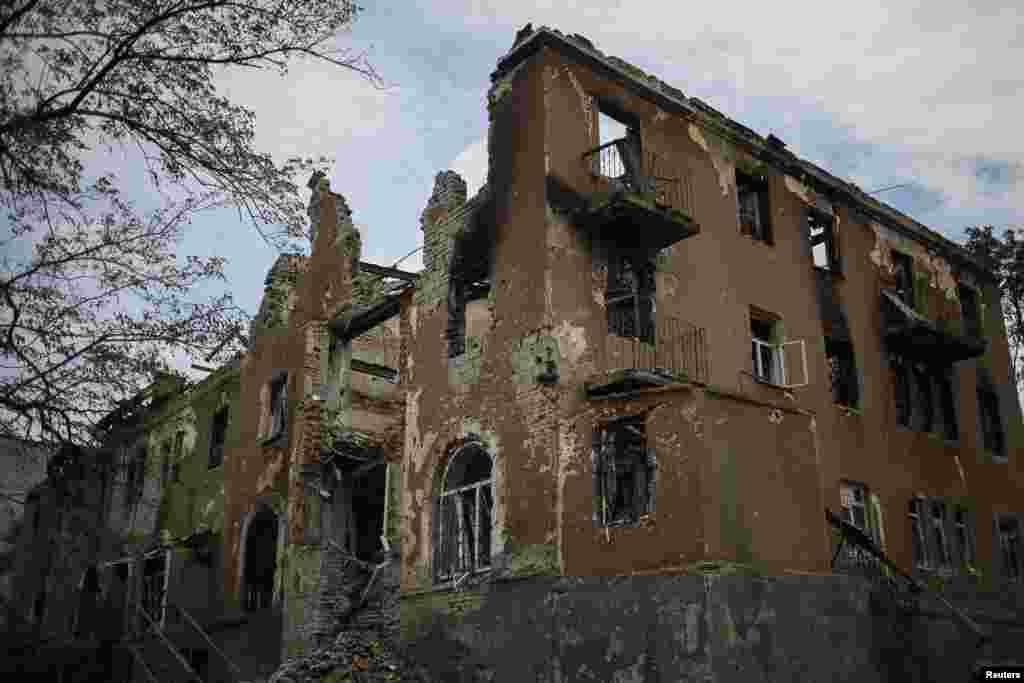 Buildings damaged by a recent shelling are seen in the eastern Ukrainian village of Semenovka, July 9, 2014.