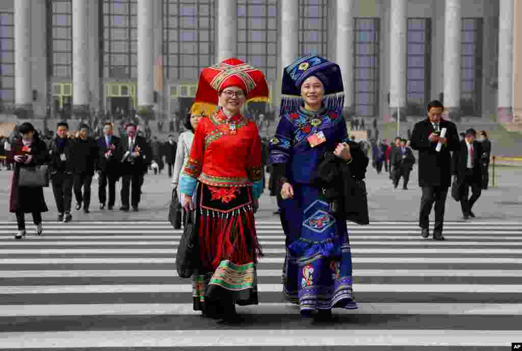 Delegates leave after attending a plenary session of China's National People's Congress (NPC) at the Great Hall of People in Beijing.