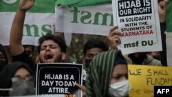Activists shout slogans during a demonstration after students at government-run high schools in India's Karnataka state were told not to wear hijabs in the premises of the institute, in New Delhi, Feb. 8, 2022.