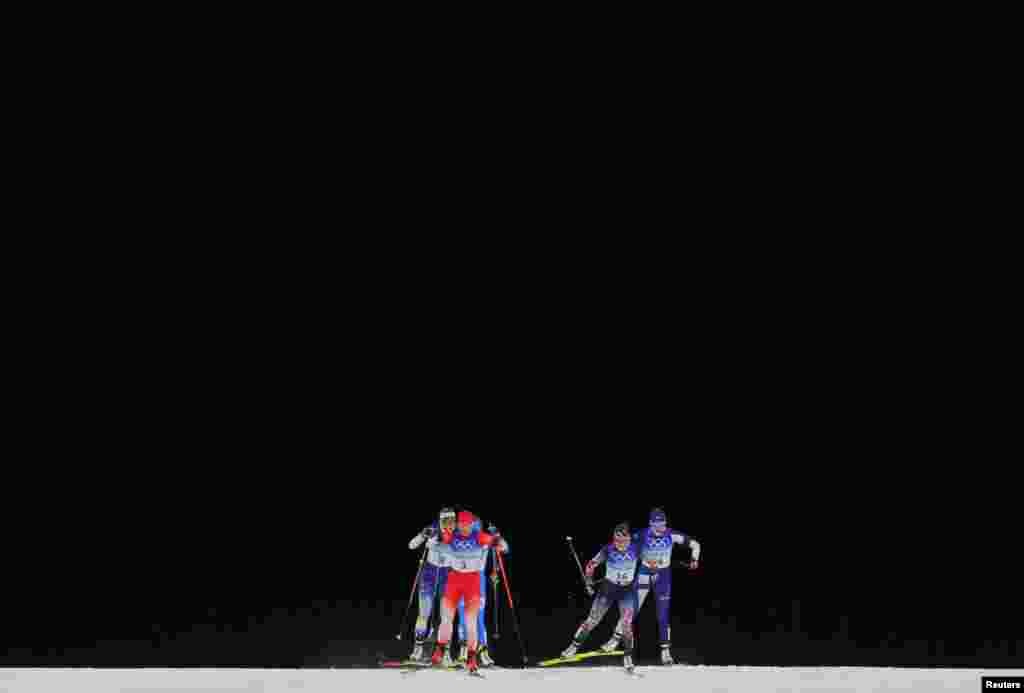 Nadine Faehndrich of Switzerland, Maiken Caspersen Falla of Norway, Victoria Carl of Germany, Anna Dyvik of Sweden, Katri Lylynpera of Finland and Lucia Scardoni of Italy compete during the women's sprint free quarterfinals at the 2022 Beijing Olympics in China.