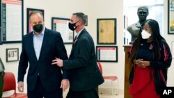 Doug Emhoff, the husband of Vice President Kamala Harris, is whisked out of an event at a high school by a Secret Service agent following an apparent security concern, in Washington, Feb. 8, 2022.
