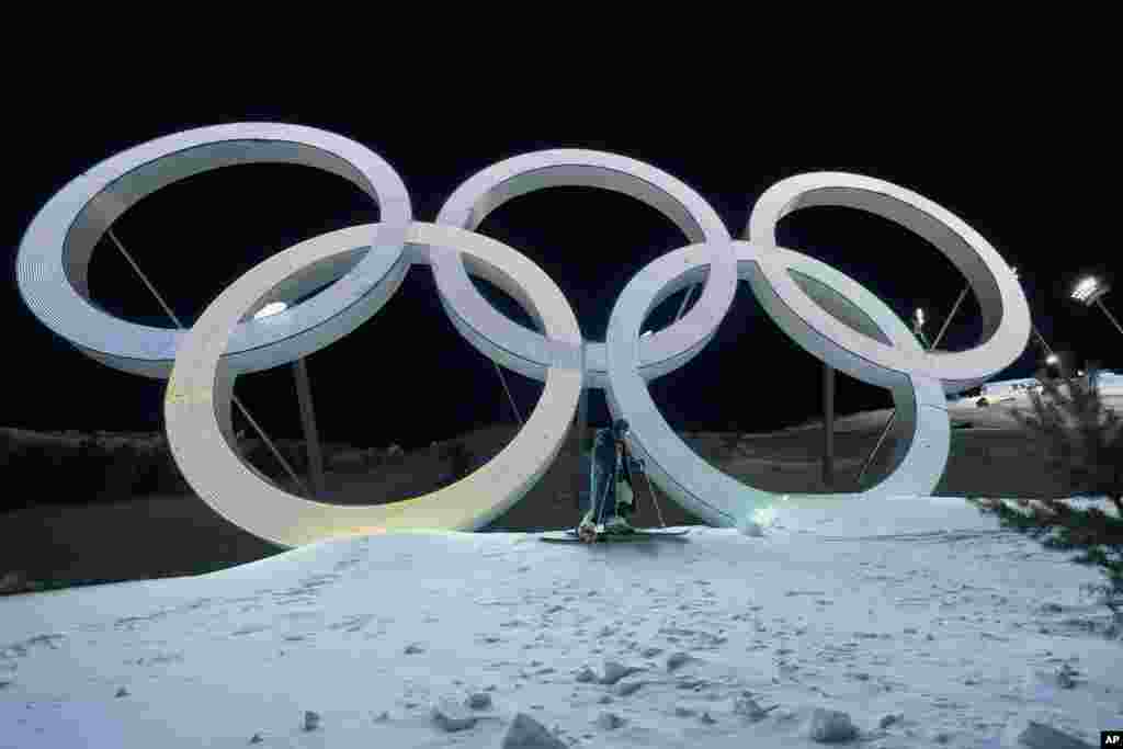 Switzerland&#39;s Marco Tade takes pictures by the Olympic rings during training for men&#39;s freestyle moguls, Feb. 1, 2022, in Zhangjiakou, China.