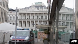 The Hotel Palais Coburg and a police car are reflected in a window before the meeting of the Joint Comprehensive Plan of Action (JCPOA) negotiators in front of the Palais Coburg in Vienna, Austria, Feb. 8, 2022.