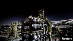 Ukrainian service members unpack Javelin anti-tank missiles, delivered by plane as part of the US military support package for Ukraine, at the Boryspil International Airport outside Kyiv, Ukraine, Feb. 10, 2022. 