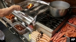 A cook at Hot Doug's cooks orders for customers at the gourmet hot dog diner in Chicago, May 7, 2014. 