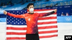 Gold medallist USA's Nathan Chen celebrates during the venue ceremony of the men's single figure skating event during the Beijing 2022 Winter Olympic Games at the Capital Indoor Stadium in Beijing on February 10, 2022. (Photo by WANG Zhao / AFP)