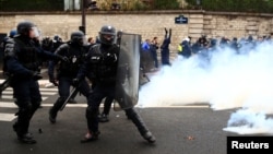 French riot police take position during clashes with French ambulance drivers as part of a demonstration at the Place de la Concorde in Paris, France, Dec. 3, 2018.