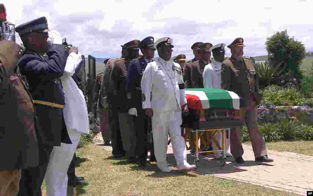 In this video frame grab, military officers escort former South African President Nelson Mandela's casket as it arrives at his burial site following his funeral service in Qunu, Dec. 15, 2013.