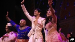 Performers from the musical Aladdin give a “curtain call” after a performance in New York City on Sept. 28, 2021. From second left, Michael James Scott as Genie, Michael Maliakel as Aladdin, and Shoba Narayan as Jasmine. (Photo Courtesy of Disney Theatrical Productions)