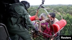 People are airlifted by the Indian Navy soldiers during a rescue operation at a flooded area in the southern state of Kerala, India, Aug. 17, 2018.