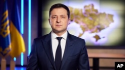 In this photo provided by the Ukrainian Presidential Press Office, Ukrainian President Volodymyr Zelenskyy addresses the nation on a live TV broadcast in Kyiv, Ukraine, Tuesday, Feb. 22, 2022.