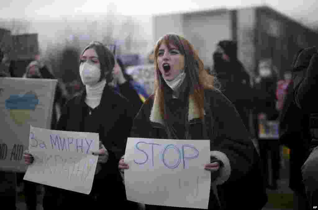 People protest against Russia and Russian President Putin after Russian troops have launched their anticipated attack on Ukraine, in front of the chancellery in Berlin, Germany, Feb. 24, 2022.
