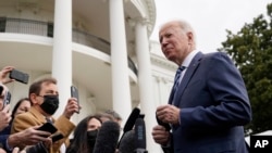 President Joe Biden speaks with the press before boarding Marine One on the South Lawn of the White House, Feb. 17, 2022, in Washington.