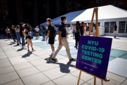 Students wait in line at a testing site for the COVID-19 set up for returning students, faculty and staff on the main campus of New York University (NYU) in Manhattan in New York City, Aug. 18, 2020.
