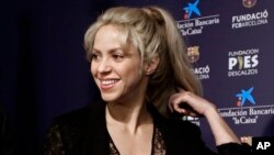 FILE - Pop singer Shakira smiles before a press conference for a charity event at Camp Nou stadium in Barcelona, Spain, March 28, 2017.