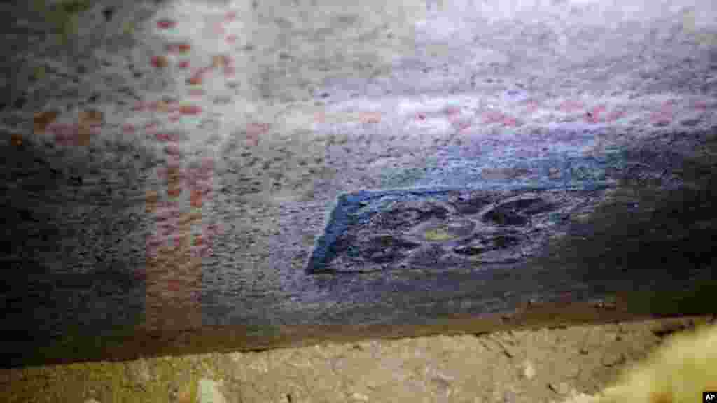 A photo of a marble panel, 4.2 meters (14 feet) long by 1 meter (3.3 feet) wide, carved with geometric shapes and painted dark red and yellow, is released by the Greek Culture Ministry, Sept. 7, 2014.