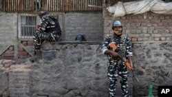 Indian paramilitary soldiers stand guard outside the main telephone exchange building in Srinagar, Indian controlled Kashmir, Sept. 5, 2019.