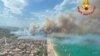 In this photo released by the Italian Firefighters, a view of a violent wildfire that burned the historical pinewood in Pescara, central Italy, Aug. 1, 2021.