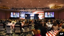 Audience members listen to President Donald Trump's remarks at a Salute to Service at a Salute to Service charity dinner in conjunction with the PGA Tour's Greenbrier Classic at The Greenbrier in White Sulphur Springs, W.Va., Tuesday, July 3, 2018.