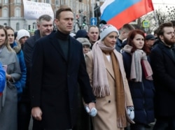 In this photo taken on Saturday, March 29, 2020, Russian opposition activist Alexei Navalny, center left, and his wife Yulia, take part in a march in memory of opposition leader Boris Nemtsov in Moscow, Russia. Russian opposition leader Alexei…