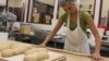 Morocco native Fatiha Outabount, 27, shapes dough at the Hot Bread Kitchen bakery in New York. (VOA-D. Grunebaum) 