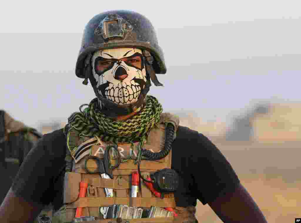 A member of Iraq's elite counterterrorism forces pauses as they advance towards the city of Mosul, Iraq.