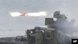 FILE - An anti-tank missile is fired during military drills in Pingtung County, Taiwan, Aug. 26, 2024. Taiwan drilled with anti-amphibious landing missiles as part of strategy to remain mobile and deadly in an attempt to deter an attack from China.