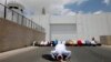 Palestinians perform Friday Prayers in front of a checkpoint along Israel's separation barrier during a demonstration to support prisoners on hunger strike in Israeli jails, West Bank town of Bethlehem, June 6, 2014.