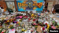 FILE - Items left by protesters to memorialize George Floyd, who died while in Minneapolis police custody, are seen at the scene of his arrest in Minneapolis, Minnesota, June 4, 2020.