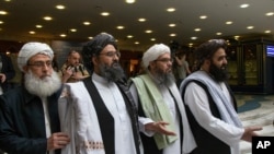 FILE - Mullah Abdul Ghani Baradar, the Taliban group's top political leader, arrives with other members of a delegation for talks in Moscow, May 28, 2019. The top Taliban negotiator says a negotiating team has been finalized for intra-Afghan negociations.