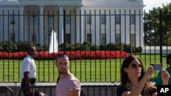 FILE - A uniformed Secret Service officer stands outside the White House in Washington, Sept. 22, 2014.
