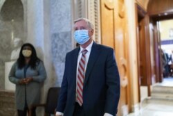 Sen. Lindsey Graham, R-S.C., leaves the chamber after taking an oath and voting on how to proceed on the impeachment against Trump, at the Capitol in Washington, Tuesday, Jan. 26, 2021. (AP Photo/J. Scott Applewhite)