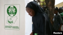 FILE - A woman casts her ballot during Nigeria's presidential election at a polling station in Kazaure, Jigawa state, Nigeria, Feb. 23, 2019. Nigerian election officials say they have recorded at least 42 attacks on its facilities since the 2019 polls.