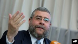 FILE - In this July 12, 2012 file photo, Rabbi Pinchas Goldschmidt, cheif of the Conference of European Rabbis, gestures during a news conference in Berlin, Germany. 