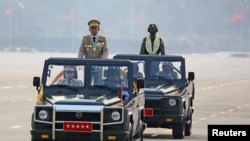 FILE - Myanmar's junta leader General Min Aung Hlaing, who ousted the country's elected government in a Feb. 1 coup, presides an army parade on Armed Forces Day in Naypyitaw, Myanmar, March 27, 2021.