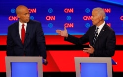 Sen. Cory Booker, D-N.J., listens as former Vice President Joe Biden speaks during the second of two Democratic presidential primary debates hosted by CNN, July 31, 2019, in the Fox Theatre in Detroit.