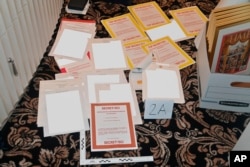 FILE - This image contained in a court filing by the Department of Justice on Aug. 30, 2022, and partially redacted by the source, shows a photo of documents seized during the Aug. 8 FBI search of former President Donald Trump's Mar-a-Lago estate.