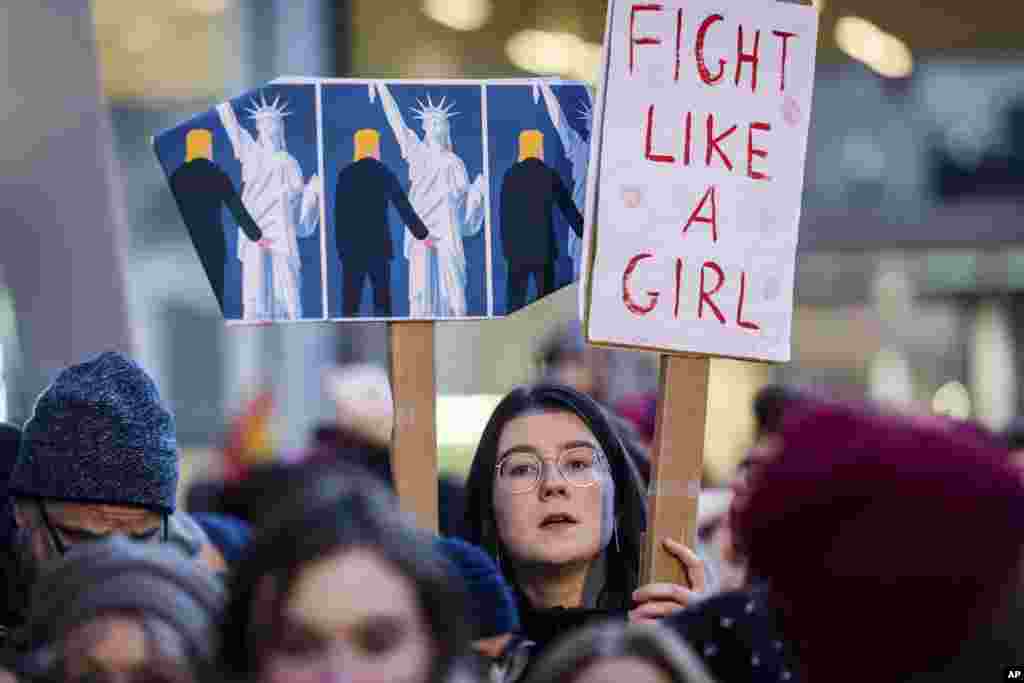 People protest in solidarity with the Women's March in Washington at the same time as the U.S. Presidential inauguration, in Brussels on Jan. 20, 2017. (AP Photo/Geert Vanden Wijngaert)