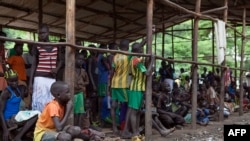 FILE - Children displaced by fighting in South Sudan wait to be registered into the Kule 1 and 2 camps for Internally Displaced People at the Pagak border crossing in Gambella, Ethiopia, July 10, 2014.